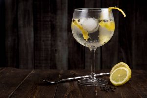 Gin and tonic with peppercorns. Gin tastings are a great Christmas party activity.