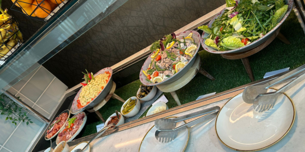Professionally prepared salads and other cold food in a buffet, ready for event delegates to serve themselves