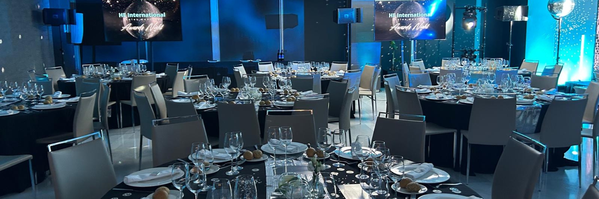 a large room with tables and chairs set up for an international employee conference